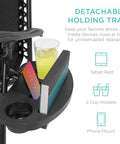 Close-up of cup holder tray with drink, book, and phone on adjustable zero gravity lounge chair.