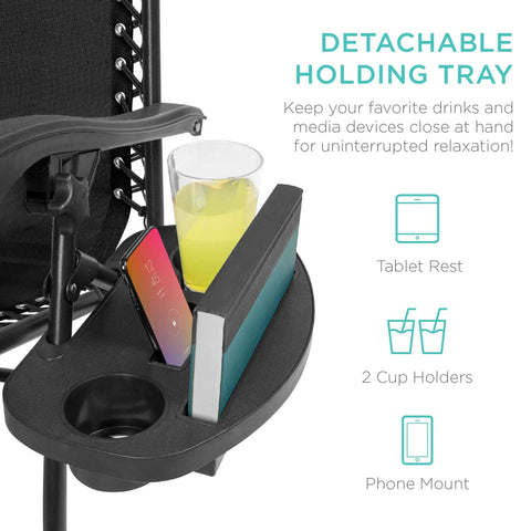 Close-up of cup holder tray with drink, book, and phone on adjustable zero gravity lounge chair.