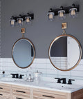 Calhoun Collection Clear Glass Farmhouse Bath Vanity Light Three Light Antique Bronze Finish above double mirrors in bathroom