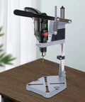 Kickass Adjustable Drill Press Stand Featuring Universal Bench Clamp And Dual Drill Mount Perfect For Rotary Tools on a workbench.