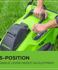 Person adjusting lever on 40V 16-Inch Brushless Cordless Lawn Mower with single lever height adjustment in green design.