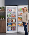 Solid 14 Cubic Foot Upright Freezer Featuring Adjustable Wire Shelves And Hassle Free Frost Cooling, fully stocked in kitchen.