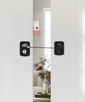 Sliding Barn Door Lock With Exterior Keyed Lock For Indoor And Outdoor Use on white door, showing installation view.