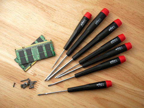 PicoFinish Mini Precision Screwdriver Set, 7-Piece Slotted And Phillips with rotating caps beside electronics parts on wood surface