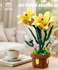 DIY Lily Bonsai Building Set For Adults, Maintenance Free Indoor Plant Decor, 296 Piece Flower Building Blocks Kit For Home Office, Living Room, Gift For Moms, Women, And Girls On Birthdays Or Mother's Day. Yellow lily block flowers in a brown pot on a table.