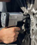 Get Your Hands On This Fifty Piece Air Tool Kit Complete With A Powerful One And A Half Inch Impact Wrench in use on car wheel