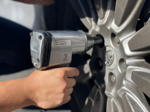 Get Your Hands On This Fifty Piece Air Tool Kit Complete With A Powerful One And A Half Inch Impact Wrench in use on car wheel