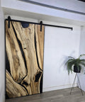 Handcrafted Live Edge Spalted Hackberry Barn Door With Custom Sizing Made To Order In Minnesota Totally One Of A Kind Rustic Modern Wood Door For Hallway Or Entryway, featuring a dark maple frame.