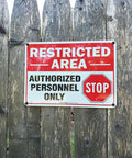 Straight Up Tough Restricted Area Sign Authorized Personnel Only Do Not Enter Safety Plaque on wooden fence, red and white design.