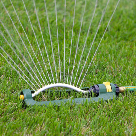 TurboTek 3200 Sq Ft Oscillating Sprinkler With 16 Rubber Nozzles QuickConnect Adapter on green lawn