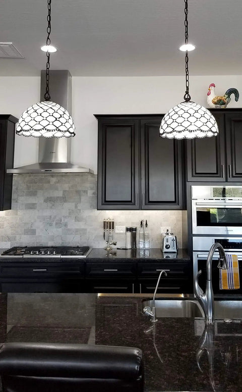 Kitchen with two Tiffany Style Hanging Pendant Lamp 12 Inch Stained Glass With White Jeweled Inset over a marble island.