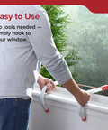 Man demonstrating Emergency Home Fire Escape Ladder Rope 3 Story Extendable To 25 Feet Must Have No Fuss Window Mount