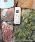 Front view of white La Crosse Technology wireless fridge/freezer thermometer with digital display and magnetic back.