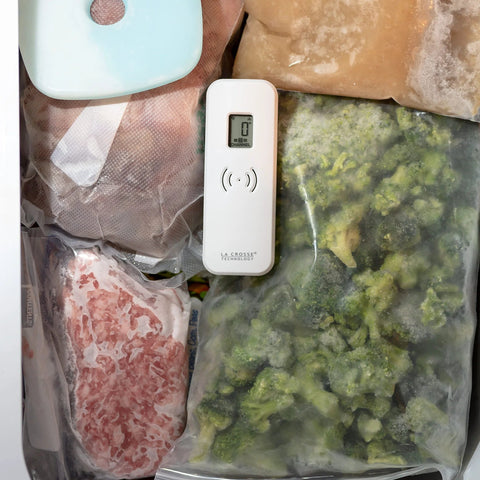 Front view of white La Crosse Technology wireless fridge/freezer thermometer with digital display and magnetic back.