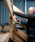 Professional using Badass 18 Volt Cordless Brushless Drill Driver Delivering 60 Newton Meters Of Torque And A Featherweight 2 Pound Build.