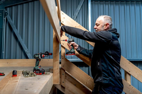 Professional using Badass 18 Volt Cordless Brushless Drill Driver Delivering 60 Newton Meters Of Torque And A Featherweight 2 Pound Build.
