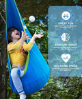 Child playing in a blue Kids Pod Swing Seat Cotton Hammock Chair for Indoor and Outdoor Play, hanging from a tree.