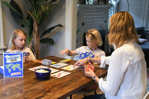 Continent Race Geography Board Game For Kid Friendly Families And Friends Learn Flags And Countries From Around The World With Fun Brain Boosts Game Night Ready For Classrooms And Home played by children and adult at table