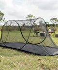 Ultra Dense Mosquito Tent With Foldable Mesh For Single Person Keeps NoSeeUms Out With TightWeave Net Perfect For Camping Travel Patio Includes Storage Bag Black set on grass in outdoor setting.