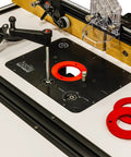 Universal Router Lift Mast-R-Lift II with built-in locking system, crank handle, and red insert rings on table.