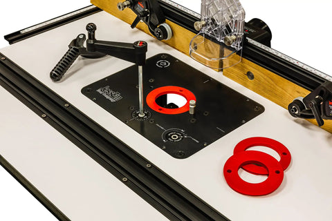 Universal Router Lift Mast-R-Lift II with built-in locking system, crank handle, and red insert rings on table.