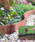 Using Heavy Duty 8 Inch Landscape Edging Stakes Set Of 60 For Paver Edging And Weed Barrier in a garden setting with spiral spike design.