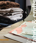 Stack of fabrics and crafting paper for use with Orange Handle Stainless Steel Scissors For All Purpose Cutting Ergonomic Design Sharp Blades For Office Crafts Paper Fabric And DIY Projects And More Everyday Creative Tasks