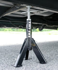 Built Tough Telescopic Rv Jack Set Of Two Adjusts Easily Between 16 And 30 Inches Quick Grip Pin Design, installed under a vehicle.