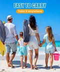Family carrying portable foldable beach chair with umbrella for adults, navy blue, lightweight for travel at the beach.