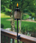 Deck Torch Mounting Bracket Kit With Four Adjustable Clamps For Rails Or Balusters, torch installed on a wooden rail with flame.