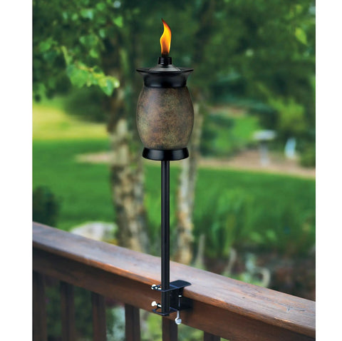 Deck Torch Mounting Bracket Kit With Four Adjustable Clamps For Rails Or Balusters, torch installed on a wooden rail with flame.