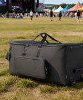 No Sweat Electronic Drum Roller Case With Thick Cushioning And Easy Rollin Wheels, Large Travel Softcase with wheels in a grass field.