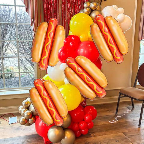 Giant Hot Dog Balloons Set Of 6 28 Inch Food Shape Party Decor for BBQ Picnic Birthday with colorful balloon backdrop indoors