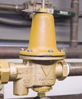 Watts LF25AUB-Z3 water pressure reducing valve, 3/4 in brass body with yellow bonnet and NPT female unions.