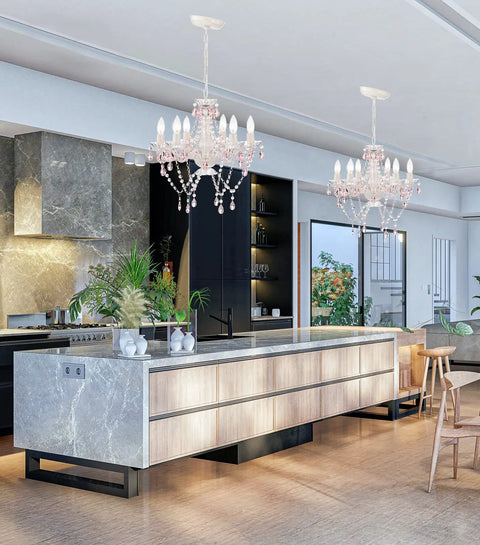 Two white crystal chandeliers with pink droplets and strands enhance kitchen decor with vintage glam lighting and scroll arm frames.