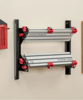 Pro Grade Spline Jig Kit For Router Table And Table Saw mounted on wall with aluminum tracks and red clamps for precise woodworking.