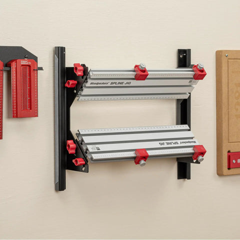 Pro Grade Spline Jig Kit For Router Table And Table Saw mounted on wall with aluminum tracks and red clamps for precise woodworking.