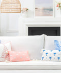 Living room couch with assorted pillows including Coastal Stripe Pillow Cover 20x20 for Indoor Outdoor Use Water Repellent Polyester Front White With Blush Pink Stripes Reverses To Solid Blush Pink Fringe Edge With YKK Brass Zipper Perfect Chill Backyard Couch Decor