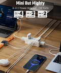 3 Ft Short Extension Cord Surge Protector Power Strip 8 In 1 with 4 AC Outlets and 2 USB C ports on a desk.