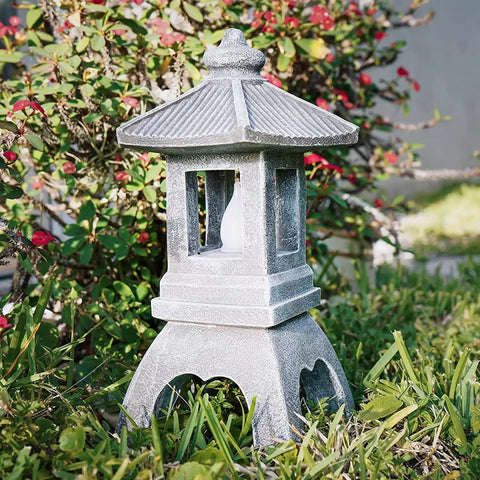 Tranquil Pagoda Solar Garden Statue with Flickering LED Lantern in outdoor garden setting