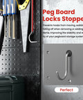 100 Pack Pegboard Hook Locks Stoppers for One Quarter Inch Peg Boards, silicone rubber accessories, black, installed on pegboard
