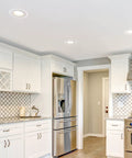 6 Inch White Goof Rings For Recessed Lights Trim 12 Pack in modern kitchen ceiling concealing lights with white cabinetry.