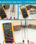 Victor VC890D digital multimeter testing a strip of axial metal-film resistors from a 3120-piece 156-value resistor kit box
