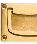Close-up of inlaid flush brass cabinet handles set of 2, overall 2.83 W x 1.89 H x 0.31 D inches, showing brass texture.
