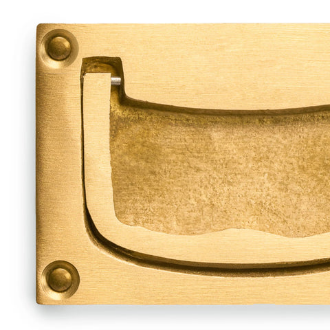 Close-up of inlaid flush brass cabinet handles set of 2, overall 2.83 W x 1.89 H x 0.31 D inches, showing brass texture.