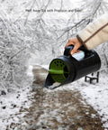 Handheld Seed Spreader For Lawn And Garden shown spreading ice melt on snowy path, 2.5L capacity, ideal for walkways.