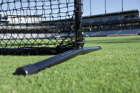 Close-up of base showing beefy steel frame of Baseball L Net Protective Screen for Batting, 7x7 ft, with quick connect joints on grass.