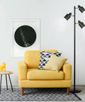 66 Inch Three Head Floor Lamp With Adjustable Heads In Satin Black Finish And Brass Accents beside yellow armchair