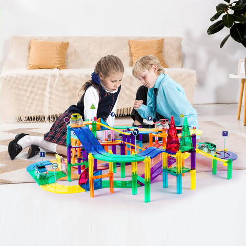 Two children playing with 150 piece race car track magnetic tile building set for kids with 4 cars, bridges, and ramps