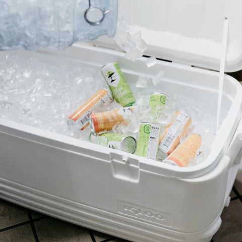 Beast Mode Heavy Duty 120 Qt Polar Cooler With UV Shield Lid filled with ice and canned drinks, open lid view